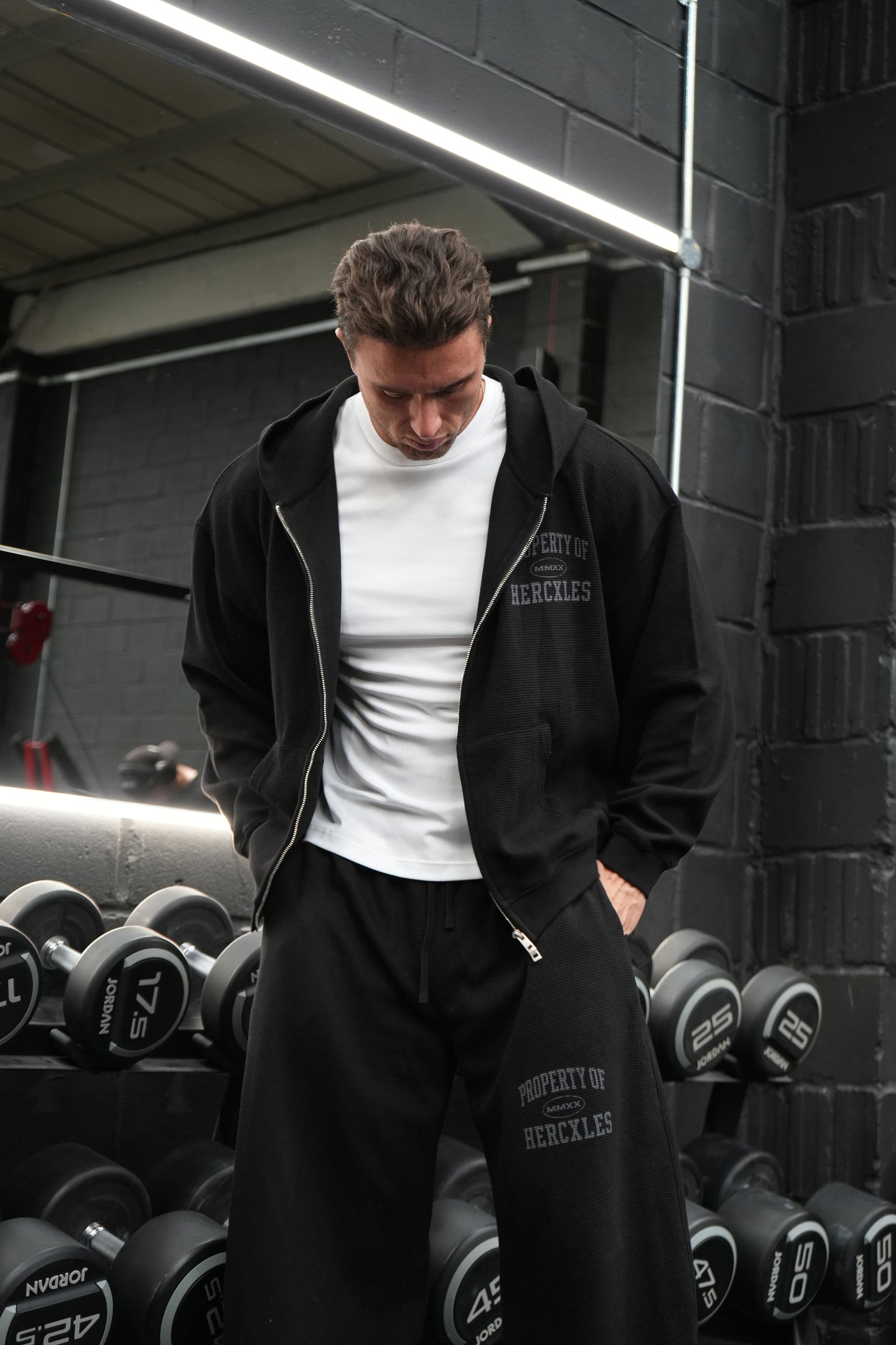 HERCXLES Property Of Waffle Barrel Leg Sweatpants - Black standing model relaxed