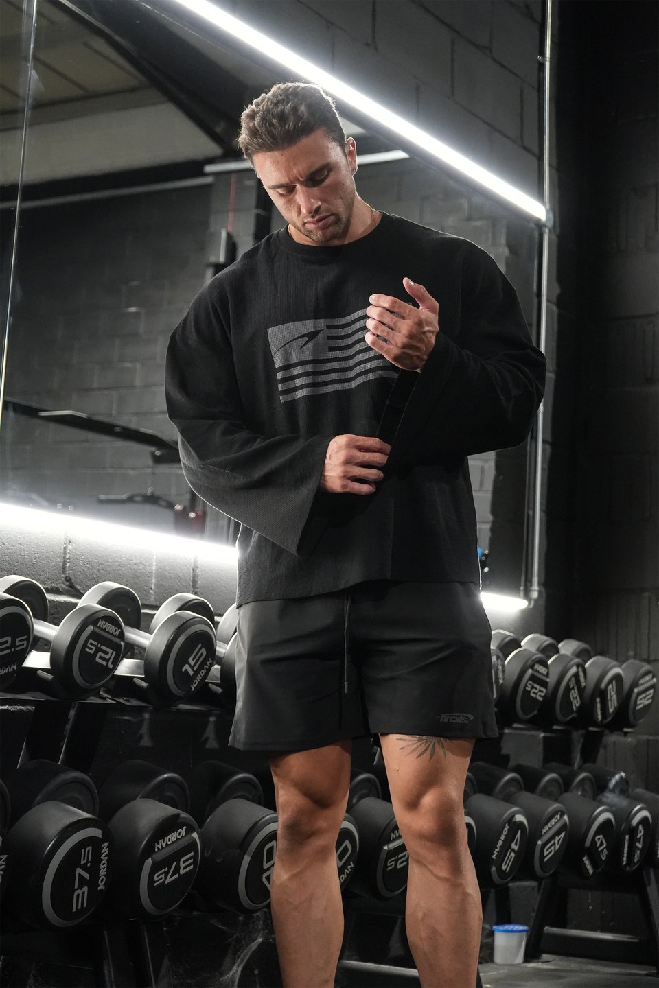 Model wearing a HERCXLES rag long sleeve in the gym