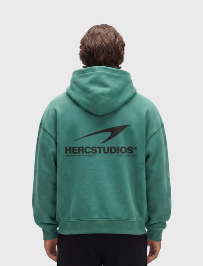 HERCSTUDIOS Hoodie - Medium Green model back