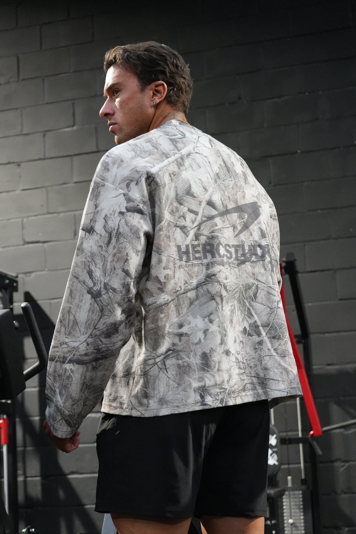 HERCSTUDIOS CAMO LONG SLEEVE - Tree Camo model back view showing the back graphic