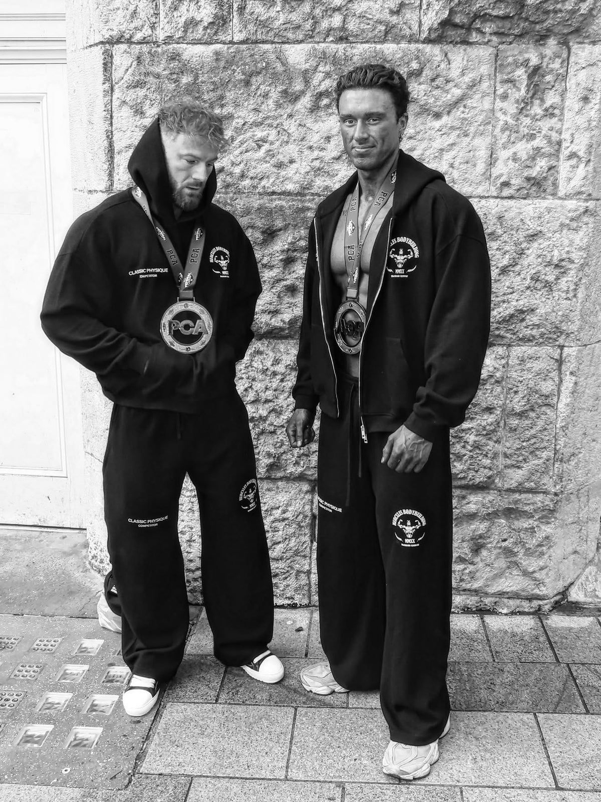 Worldwide Competitor Sweatpants - Black / White model two competitors in hoodies and joggers with medals (p6)