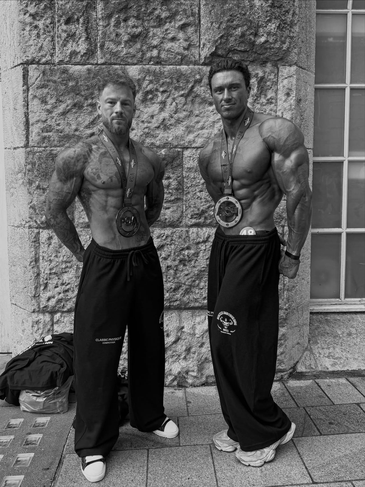 Worldwide Competitor Sweatpants - Black / White model two competitors in joggers with medals (p8)