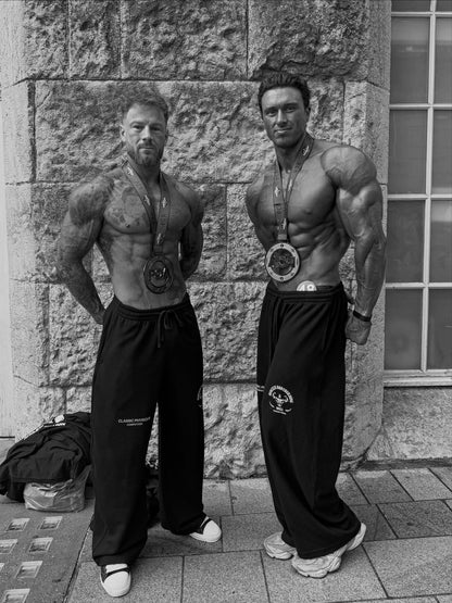 Worldwide Competitor Sweatpants - Black / White model two competitors in joggers with medals (p8)